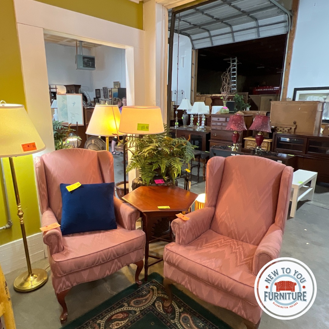 Two armchairs, a lampshade and other furniture in a Bloomington furniture consignment store.